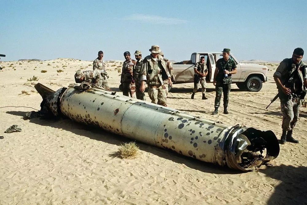 Des militaires américains devant l'épave d'un missile balistique Scud irakien intercepté en plein vol par un système Patriot durant l'opération Tempête du désert.