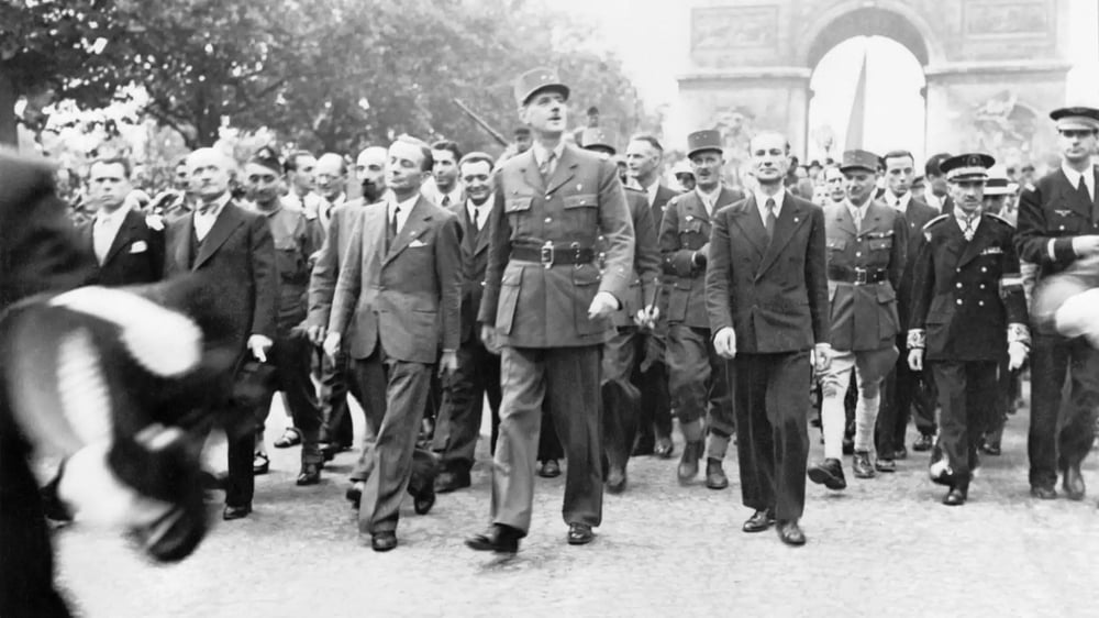 Après avoir ravivé la flamme du soldat inconnu, le général de Gaulle descend triomphalement l'avenue des Champs-Élysées (26 août 1944).