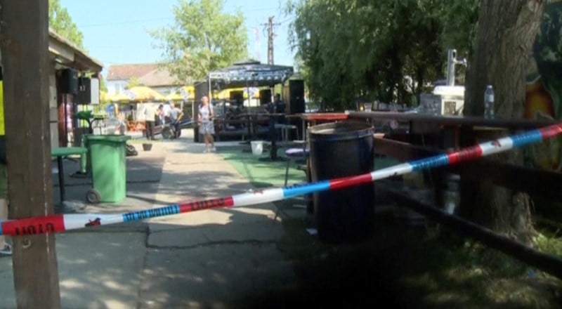 A police tape is seen in a cordoned area at a cafe after a shooting during a local festival in the village of zitiste