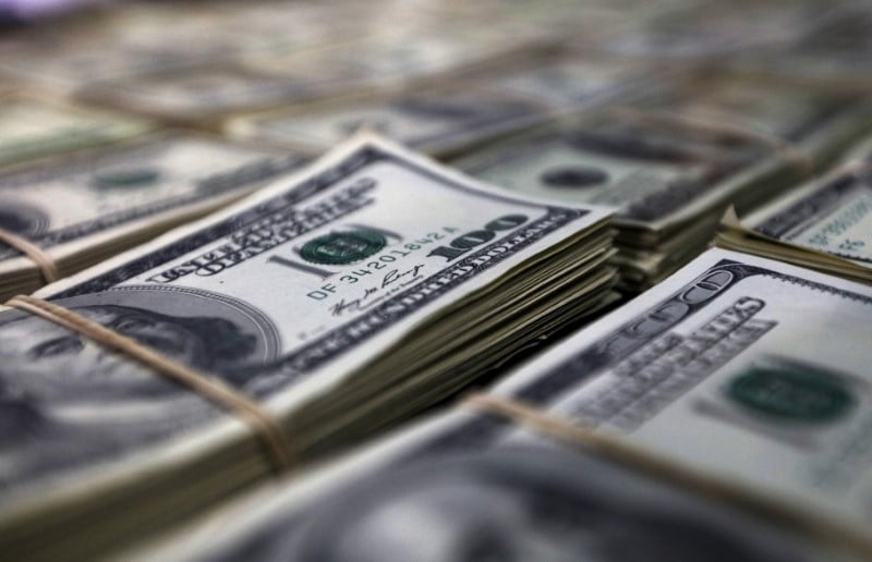 Police officers display counterfeit u.s. dollar bills during a news conference in lima