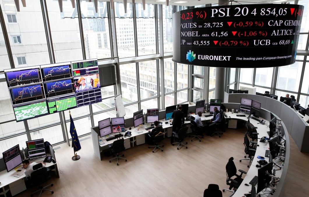 Traders work at their desks in a trading room at the stock market operator euronext headquarters in la defense business and financial district in courbevoie near paris
