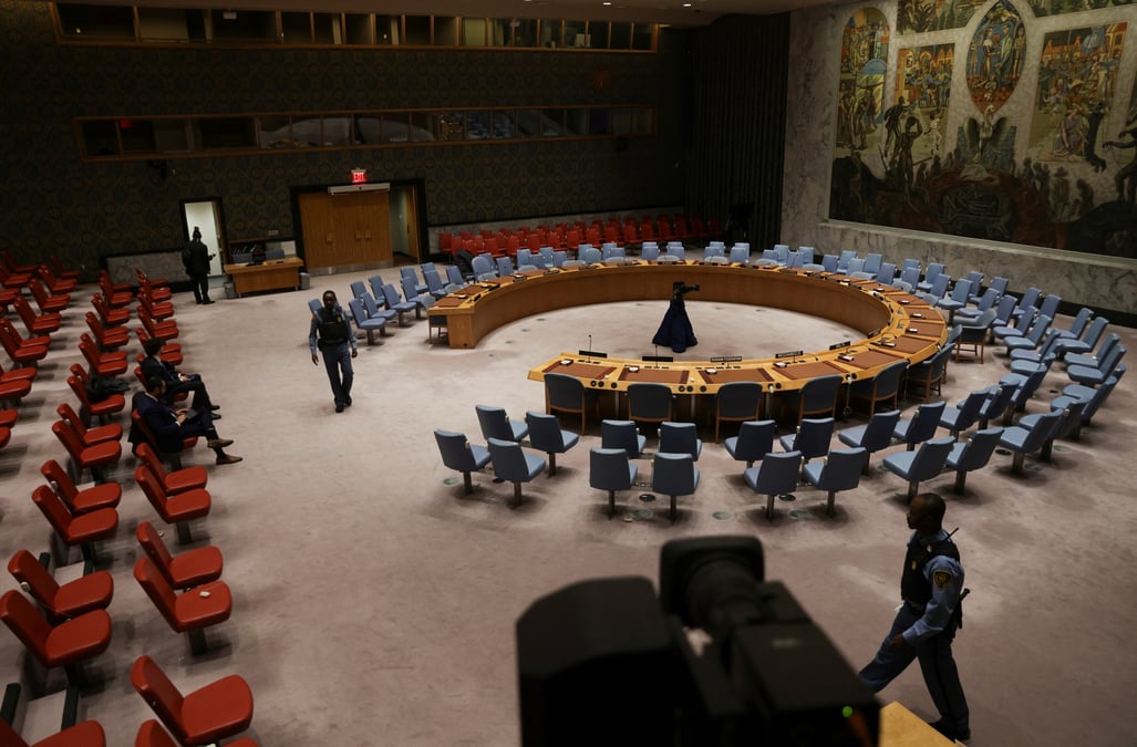 Le personnel de securite marche dans la salle du conseil de securite des nations unies avant une reunion pour voter sur une proposition visant a exiger qu'israel et le hamas autorisent l'acces de l'aide a la bande de gaza