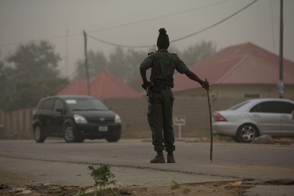 File photo: a policeman keeps watch on the road leading to taraba state electoral commission during the announcement of the results of the governorship and state assembly elections in jalingo