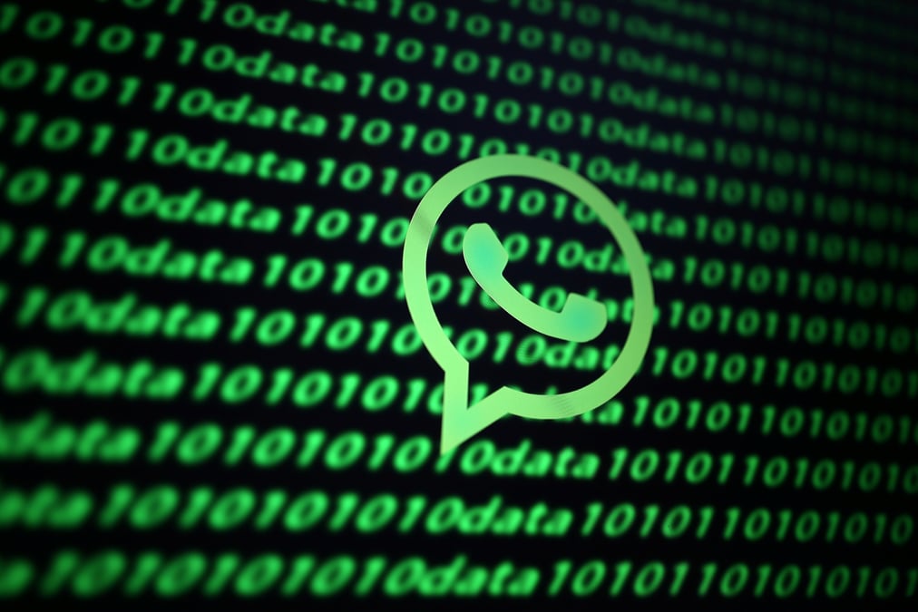 The whatsapp logo and binary cyber codes are seen in this illustration