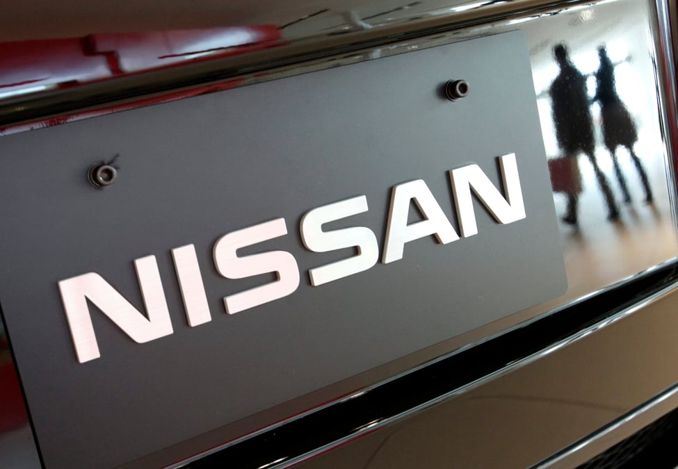 Visitors are reflected in a nissan motors' vehicle at the company's global headquarters in yokohama