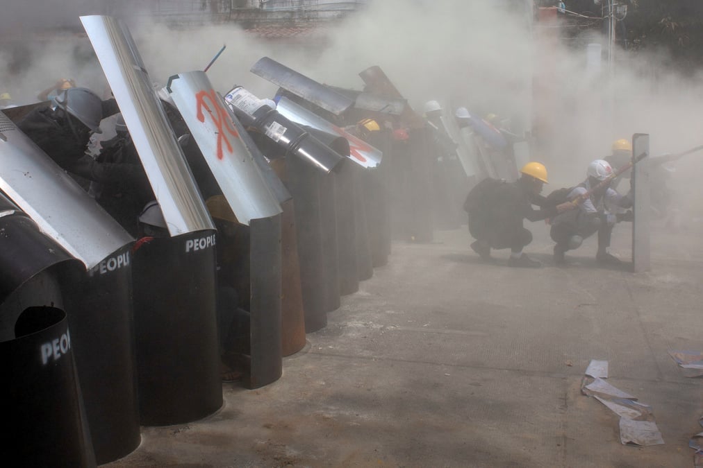 Protesters cover with makeshift shields during an anti-coup protest in yangon