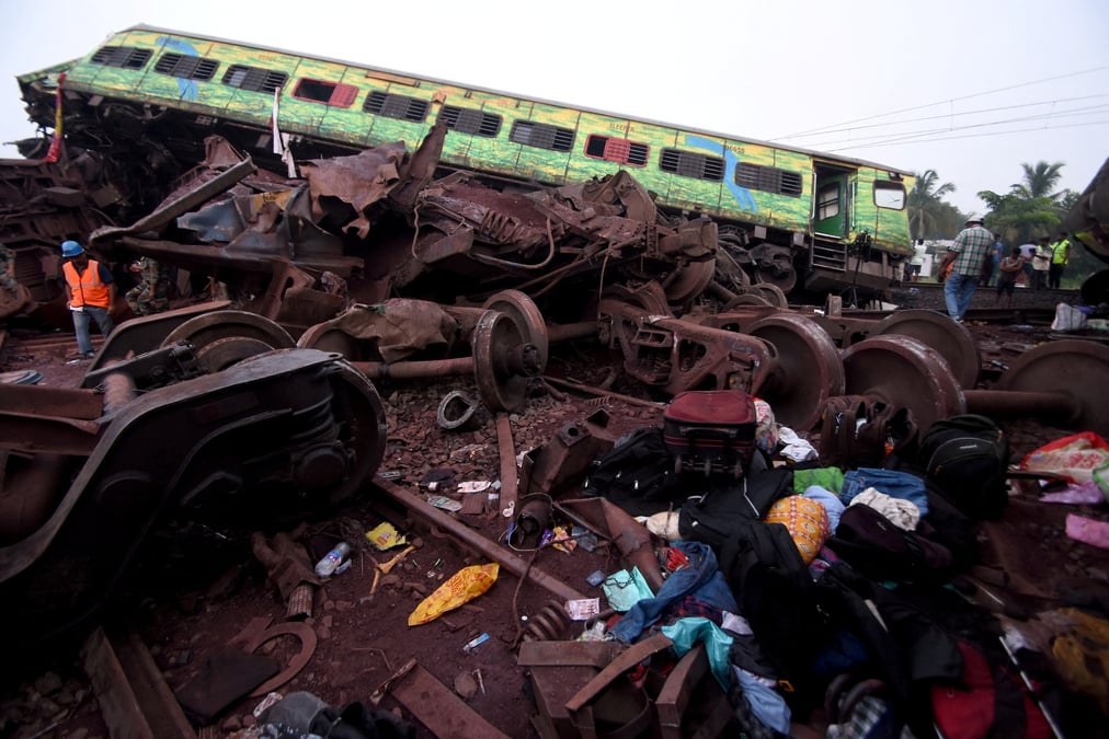 Les effets personnels des passagers a cote d'un wagon endommage apres une collision meurtriere en inde