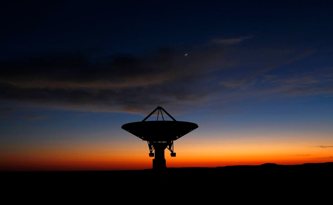 Dawn breaks over a radio telescope dish of the kat-7 array pointing skyward at the proposed south african site for the square kilometre array