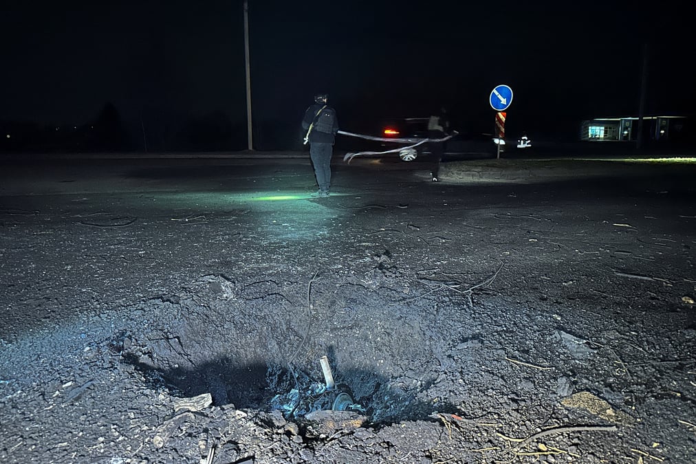 Des policiers travaillent a cote d'un cratere apparu apres une frappe de drone russe, dans le cadre de l'attaque de la russie contre l'ukraine, a kharkiv