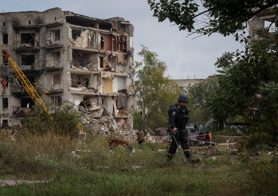 Les autorites travaillent autour et a l'interieur d'un immeuble residentiel endommage par une frappe militaire russe a izium, ukraine