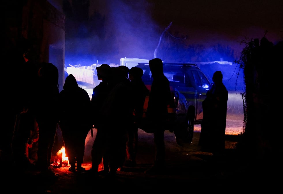 Des spectateurs se rassemblent sur les lieux a la suite d'une fuite de gaz presumee liee a l'exploitation miniere illegale