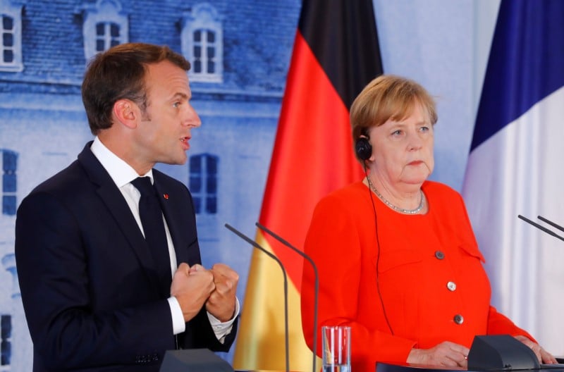 Migrants: merkel et macron demandent une reponse europeenne