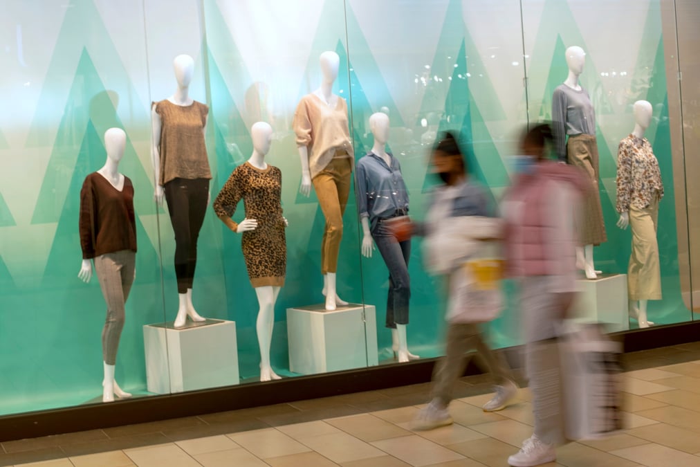 Shoppers walk past a window display of mannequins at the christiana mall in newark
