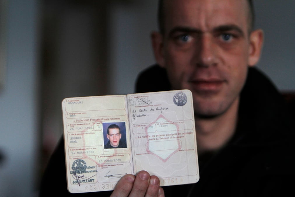 Hamouri shows his french passport during an interview with reuters near jerusalem