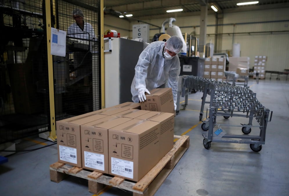 An employee wearing a protective mask works at the kolmi-hopen company's factory in saint-barthelemy-d'anjou