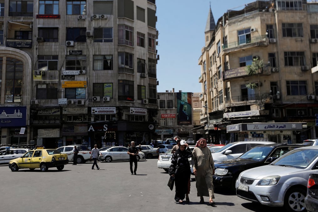 Des personnes se promenent dans une rue de damas, en syrie