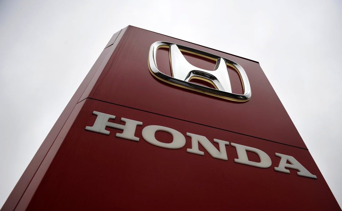 A honda sign is seen outside a dealership in ottershaw, southern england