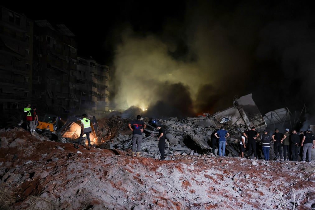 Des personnes inspectent les degats sur le site d'une frappe israelienne, a beyrouth