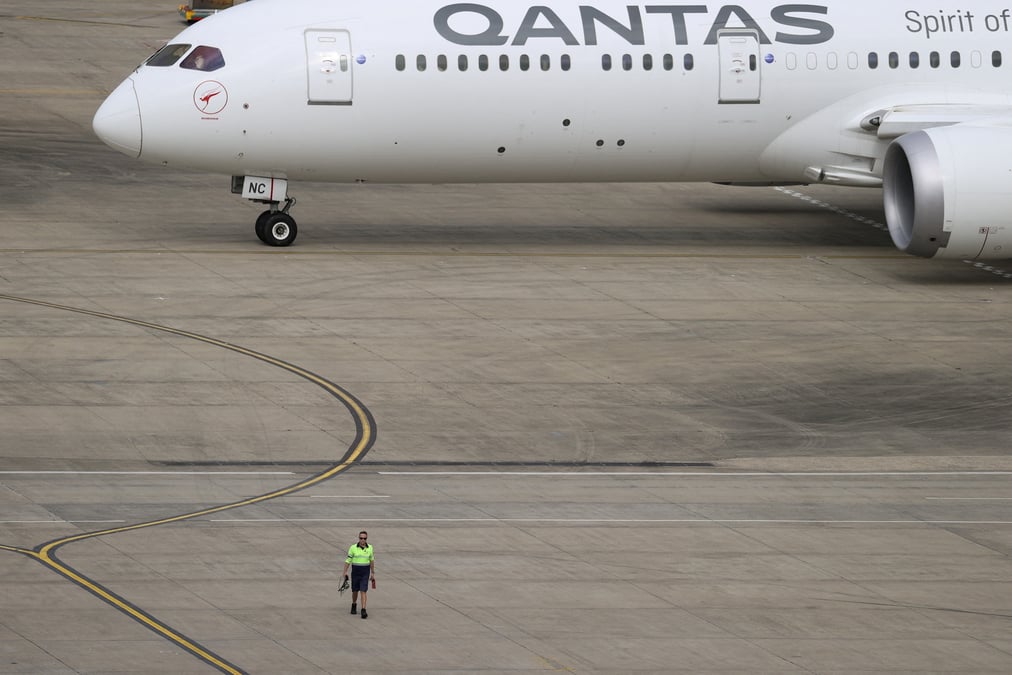 Photo d'archives d'un employe qui marche pres d'un avion qantas a l'aeroport de sydney, en australie