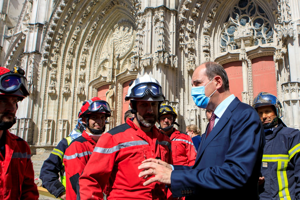 French prime minister jean castex wears a protective mask as he meets firefighters after the blaze at the cathedral of saint pierre and saint paul in nantes