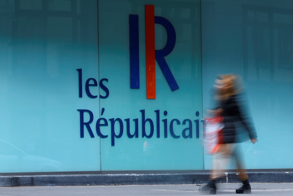 Une femme passe devant un logo du parti francais les republicains (lr) a paris, france