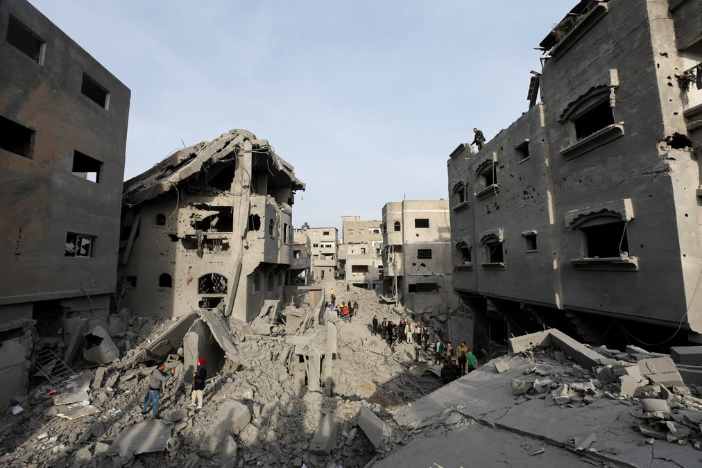 File picture palestinians inspect damage at the site of an israeli strike on a house, at nuseirat refugee camp