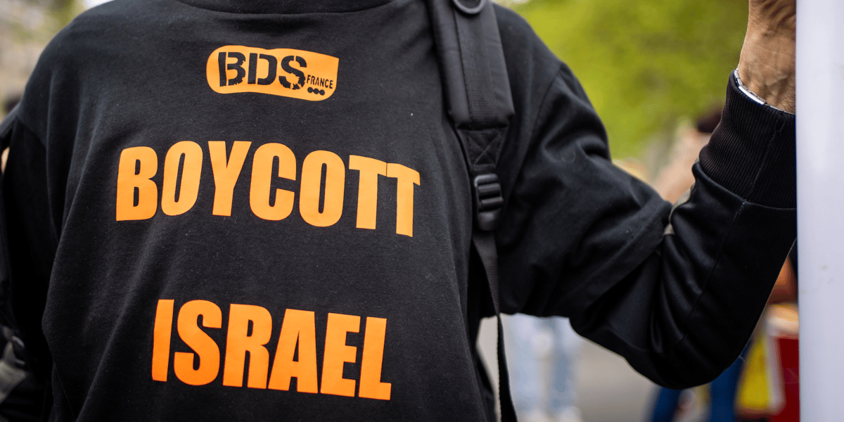 Manifestation antiraciste à Paris le 29 avril 2023 contre le projet de loi d'asile et immigration et contre l'opération Wuambushu d'expulsion des sans papiers à Mayotte. Un manifestant arbore un t-shirt avec le message BDS France. L'action BDS (Boycott Desinvestissement Sanctions) a été lancée par la société civile palestinienne en 2005, suite a des dizaines d'années de lutte contre Israël et sa politique de colonisation des territoires occupés.