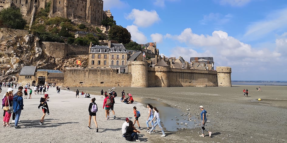 Pour accéder au Mont-Saint-Michel, les visiteurs empruntent un pont-passerelle sur pilotis qui redonne au site touristique son caractère maritime.