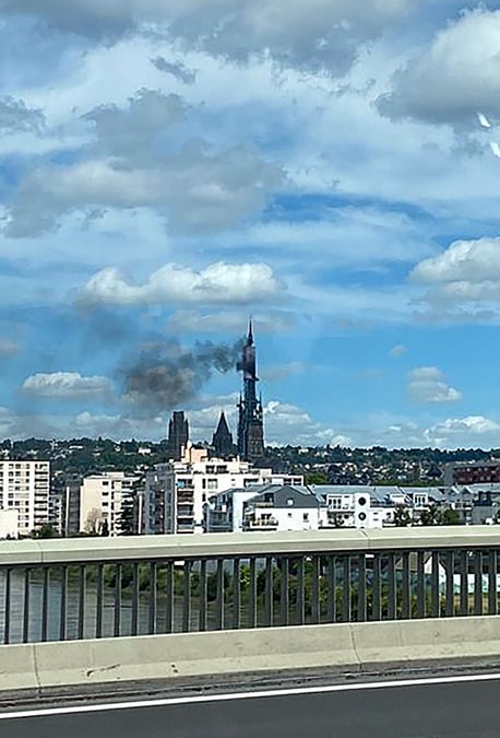 La fleche de la cathedrale gothique de la ville francaise de rouen en normandie en feu