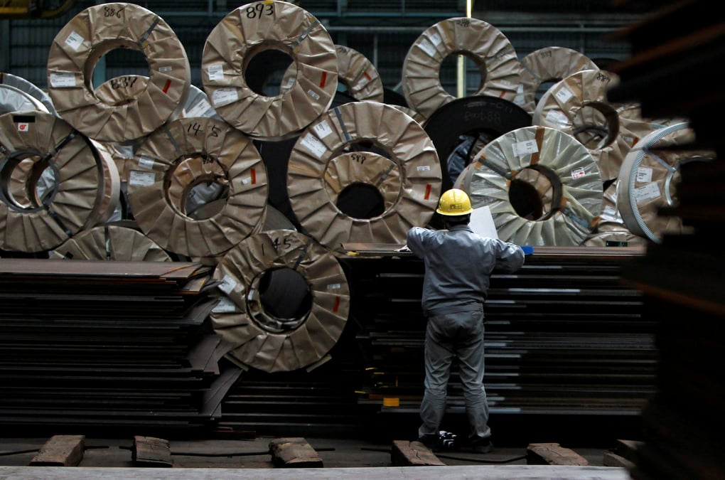 File photo - a worker checks steel coils and steel sheets at a distribution warehouse in urayasu, east of tokyo
