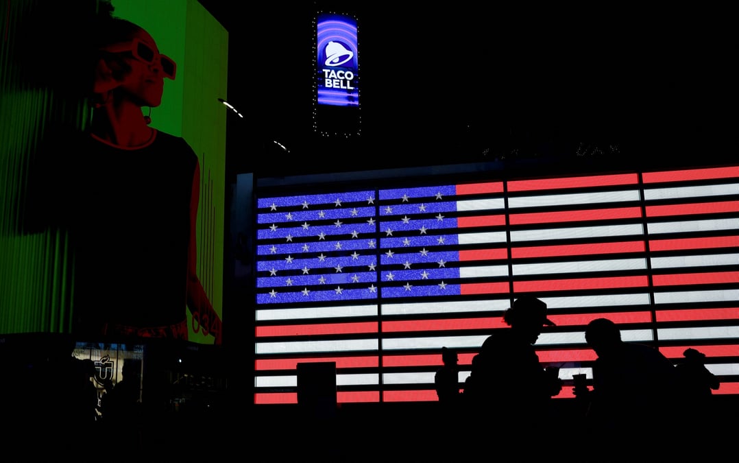 Des silhouettes devant le drapeau americain a new york
