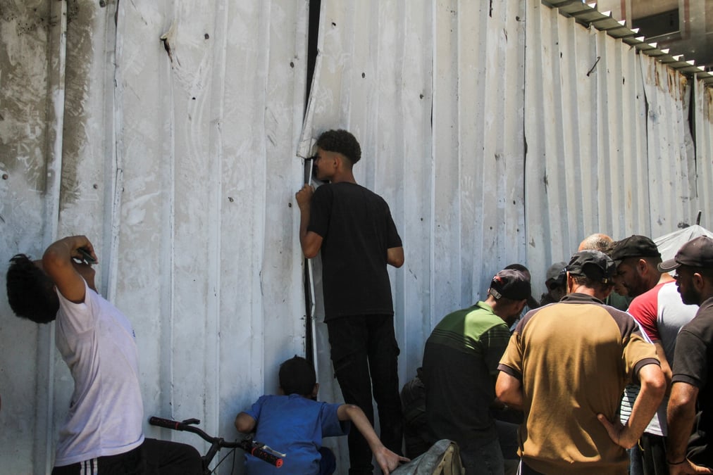 Palestinians gather to receive food at an unrwa distribution center amid a hunger crisis, in jabalia in the northern gaza strip
