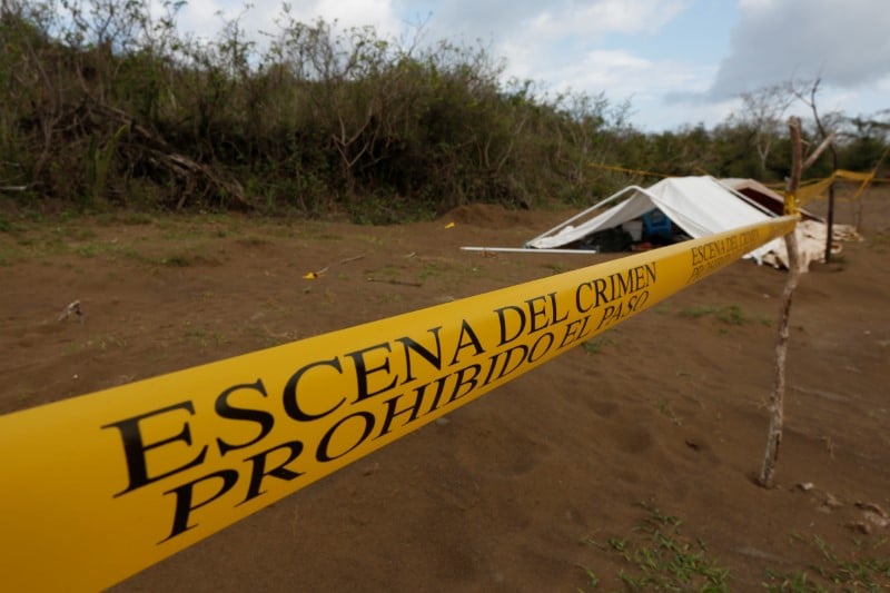 A police cordon marks the perimeter of the site where a forensic team and judicial authorities work in unmarked graves where skulls were found, on the outskirts of veracruz