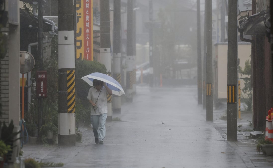 A passerby walks in heavy rain as typhoon lan hits the region tanabe, western japan