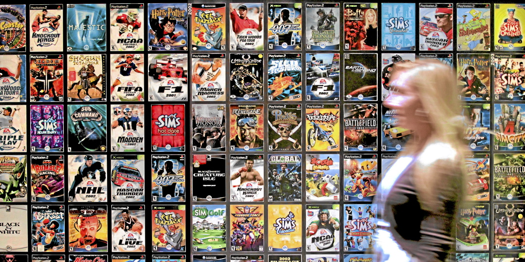 A worker walks past cases for various Electronic Arts Inc. video games at the company's headquarters in Redwood City, California, U.S., on Tuesday, July 20, 2010. Electronic Arts, the world's second-biggest video-game publisher, is in the middle of a market shift, moving away from its declining cons