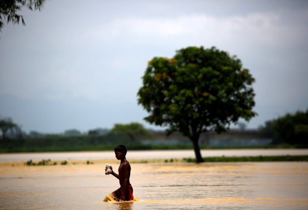 A boy walks along the flooded area in saptari district