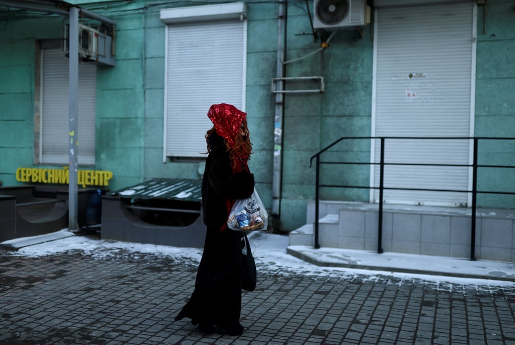 Une femme porte un sac avec de la nourriture alors qu'elle marche dans une rue a odessa, ukraine
