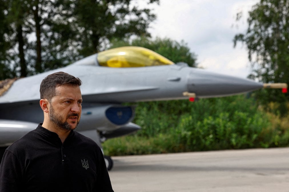 Le president ukrainien volodymyr zelenskiy devant un avion de combat f-16