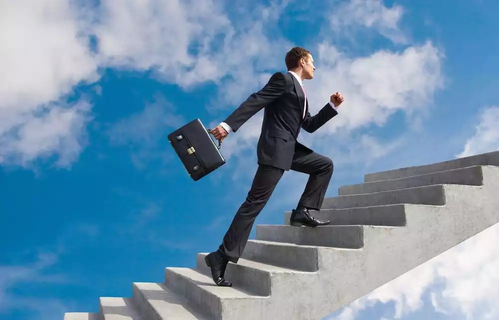 confident-businessman-with-briefcase-walking-upstairs-1000x641