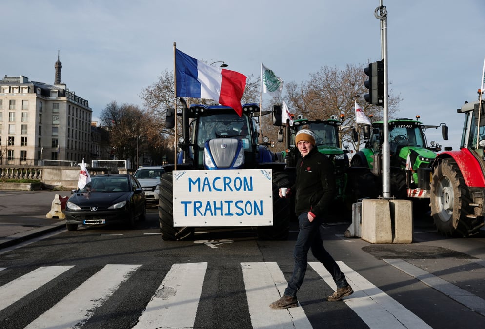 A man walks past tractors lined up as French farmers protest against the EU-Mercosur free trade agreement and the French government's agricultural policy, in Paris, France, January 13, 2026. REUTERS/Benoit Tessier - French farmers protest in Paris...
