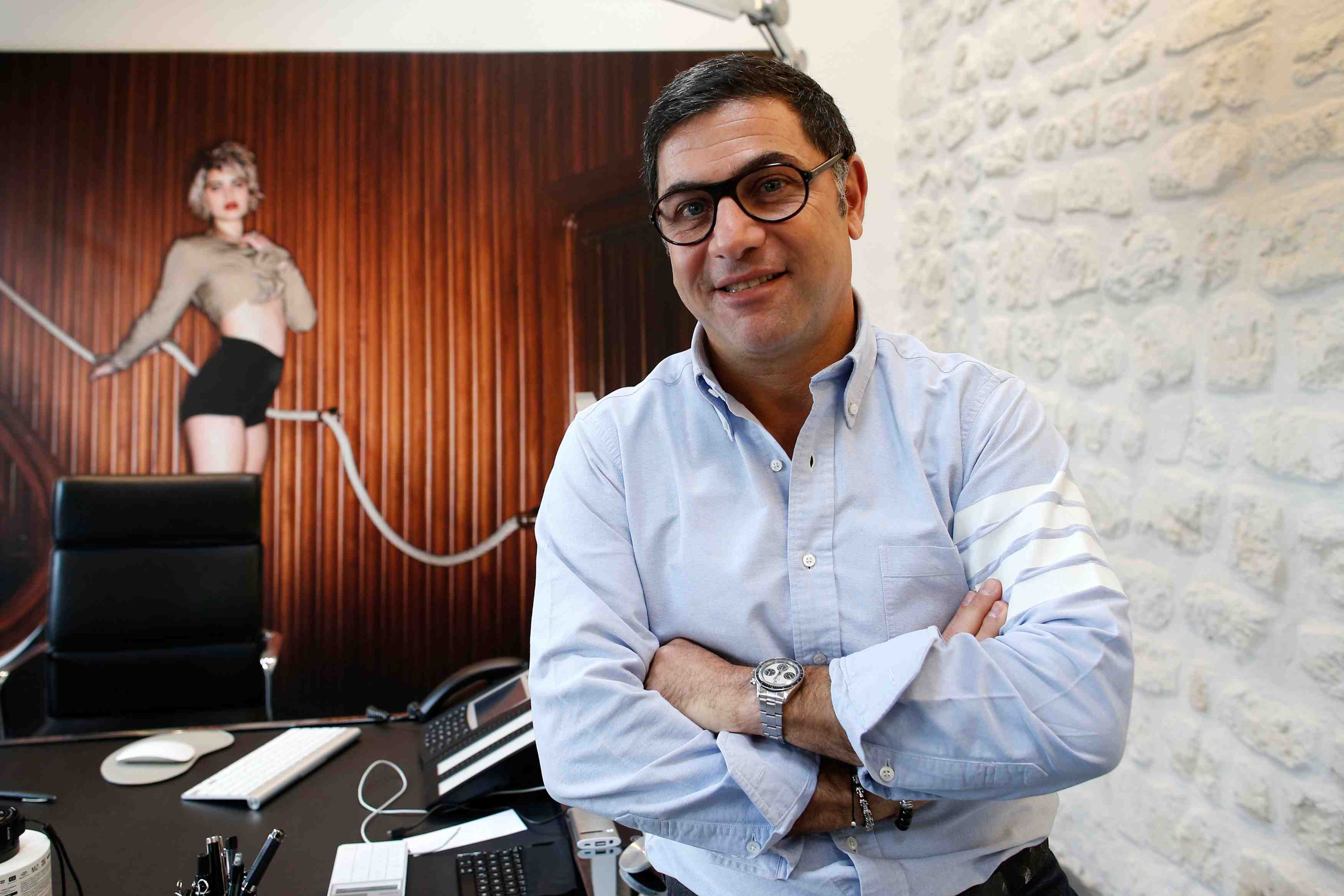 Henri sebaoun, chief executive officer of french fashion brand carven, poses at his desk after an interview with reuters in paris