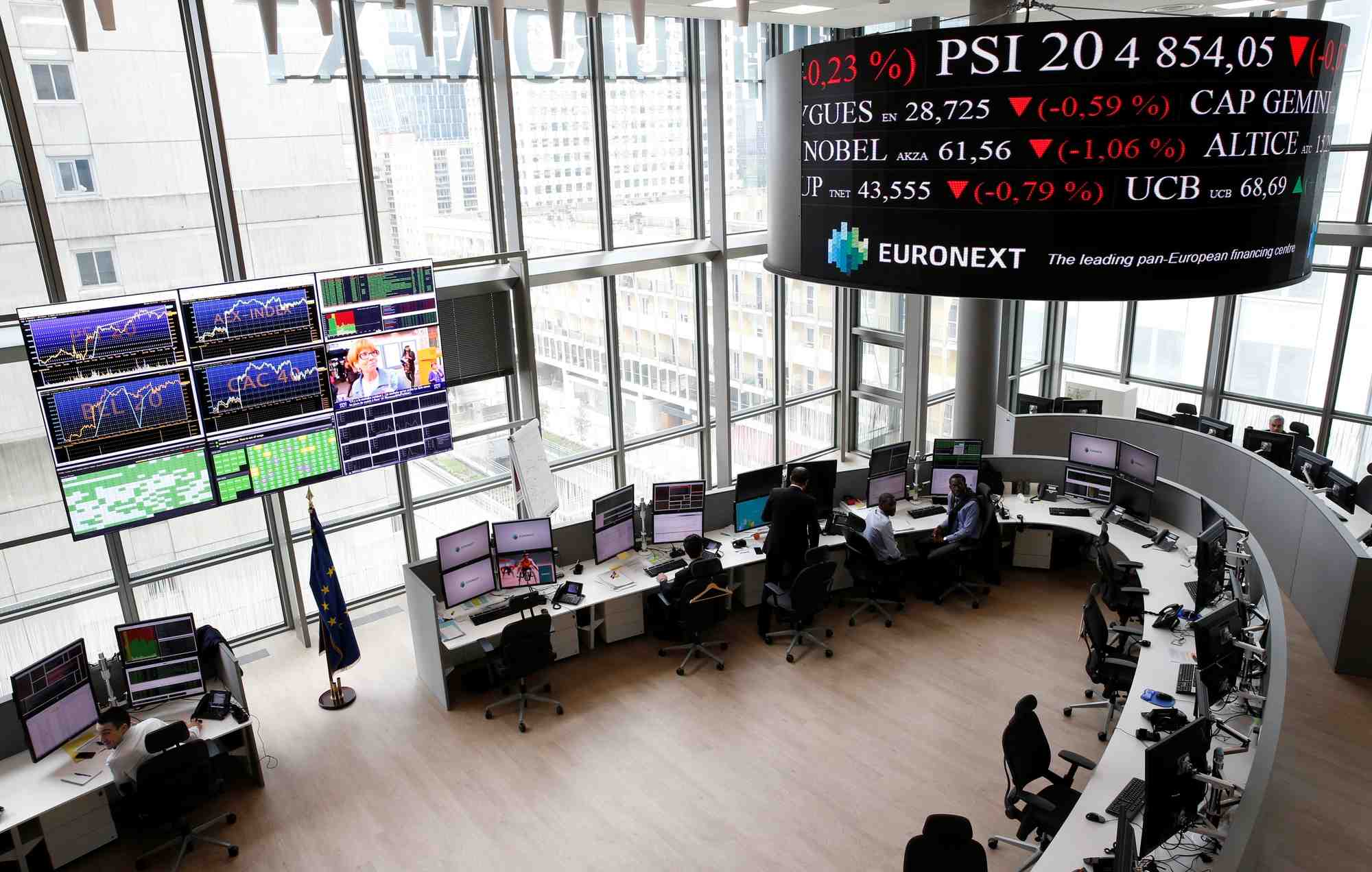 Traders work at their desks in a trading room at the stock market operator euronext headquarters in la defense business and financial district in courbevoie near paris