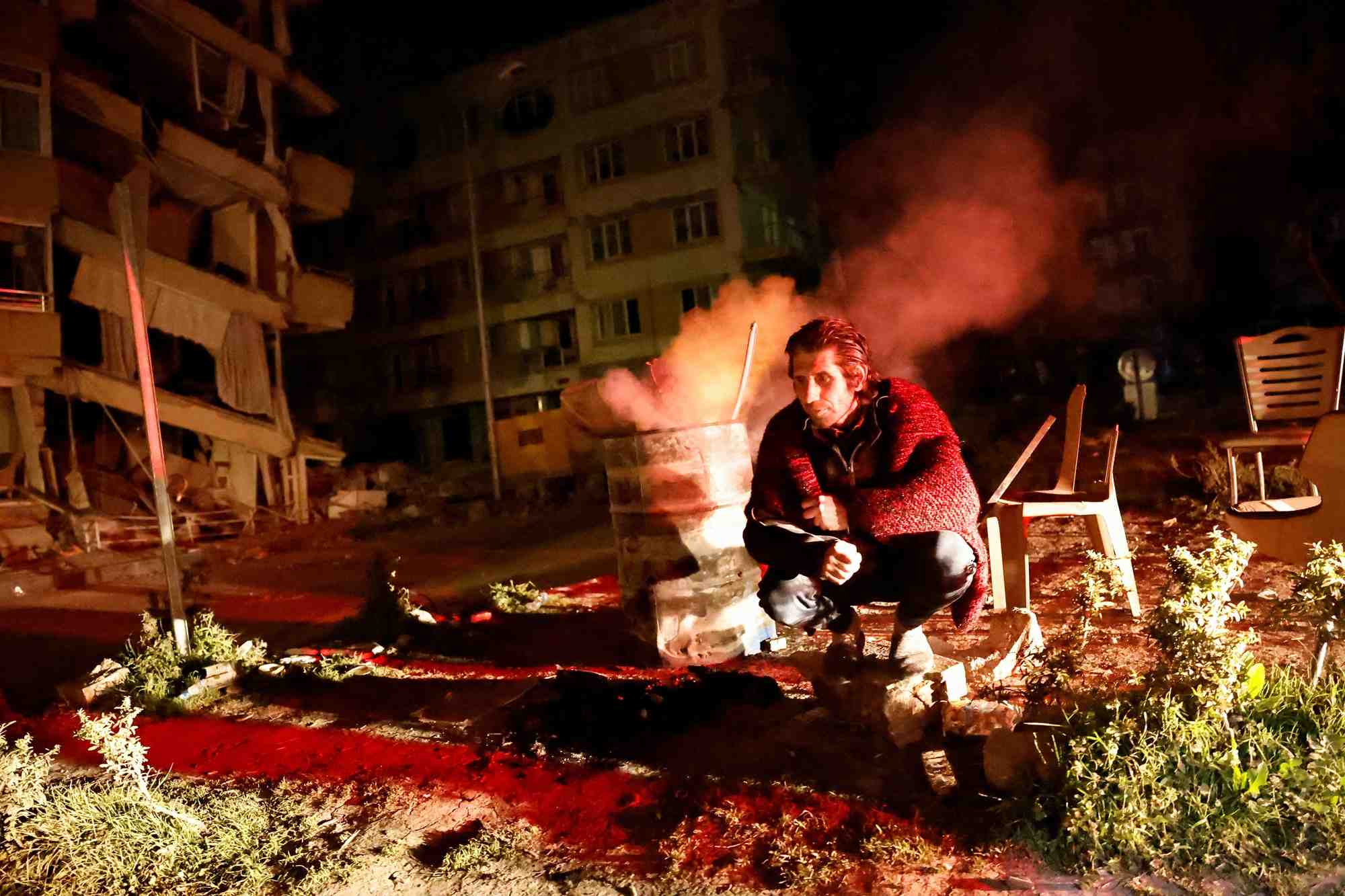 Un homme pres des batiments endommages apres un tremblement de terre a antakya, en turquie
