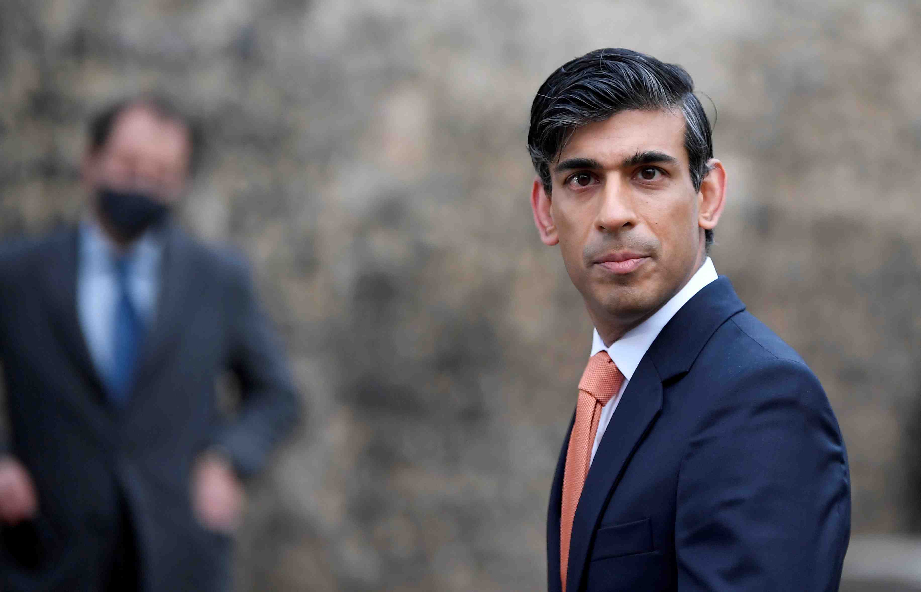File photo: britain's chancellor of the exchequer rishi sunak looks on as he leaves following an outside broadcast interview, in london