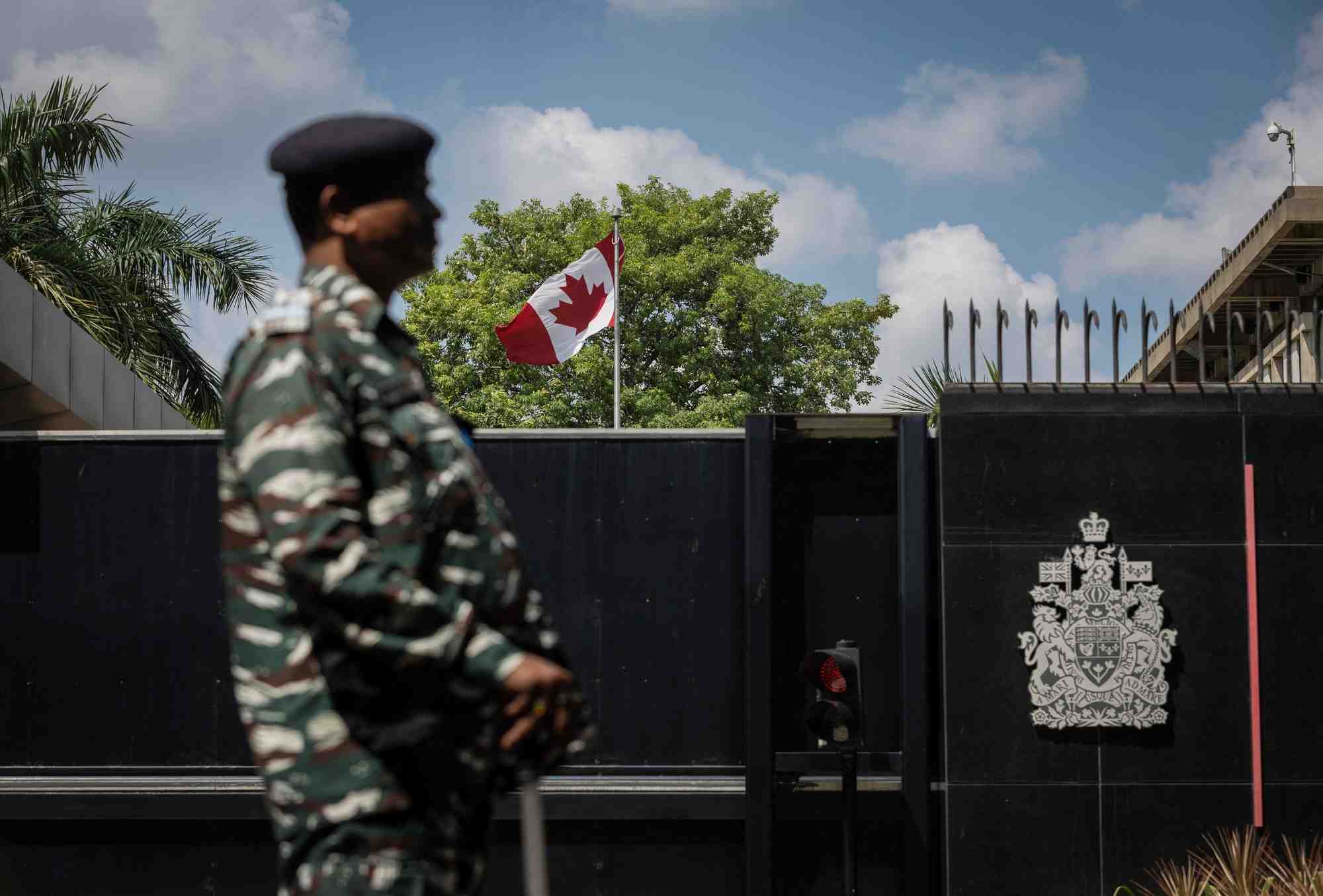 Un membre du personnel de securite monte la garde devant la haute-commission canadienne a new delhi