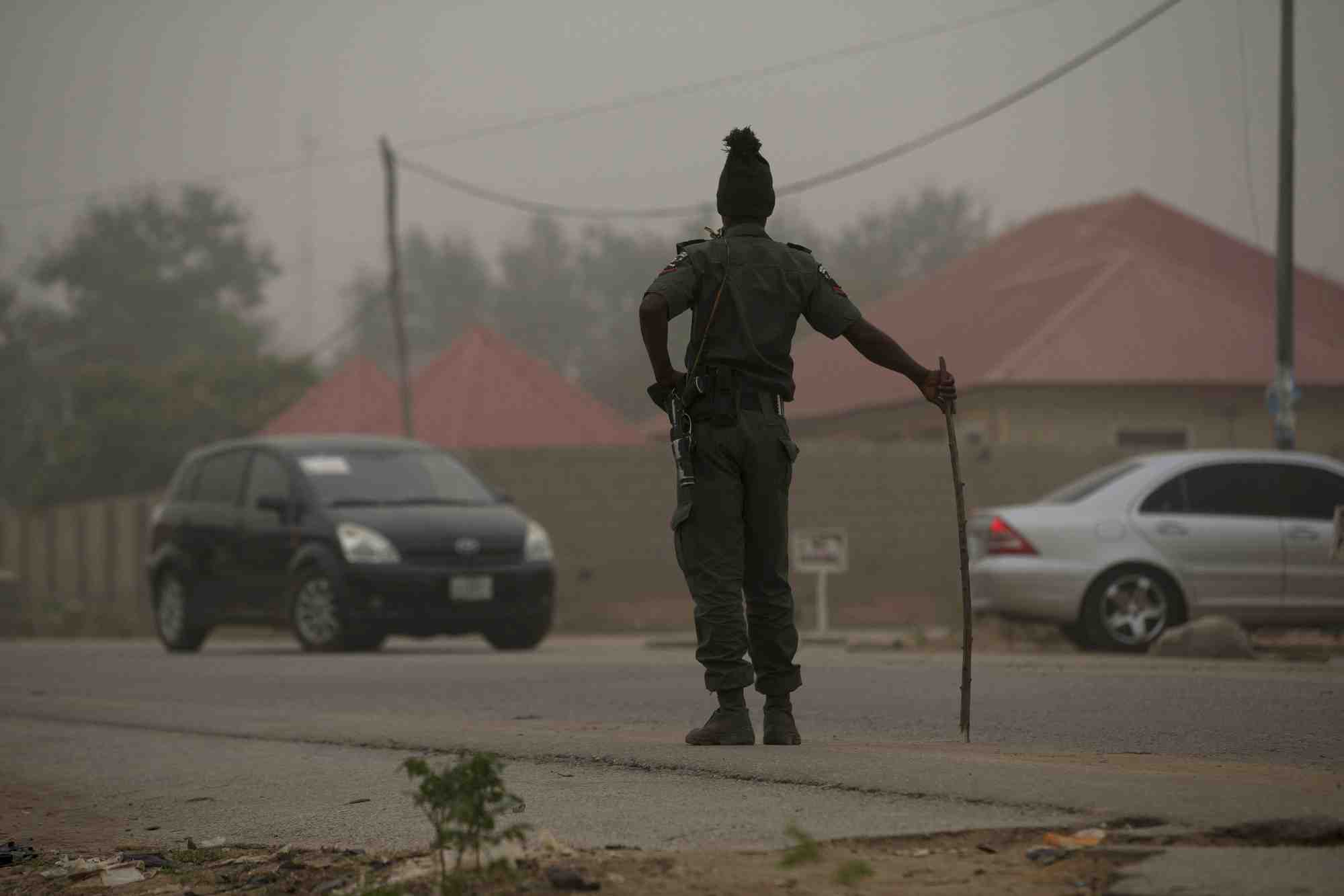 File photo: a policeman keeps watch on the road leading to taraba state electoral commission during the announcement of the results of the governorship and state assembly elections in jalingo