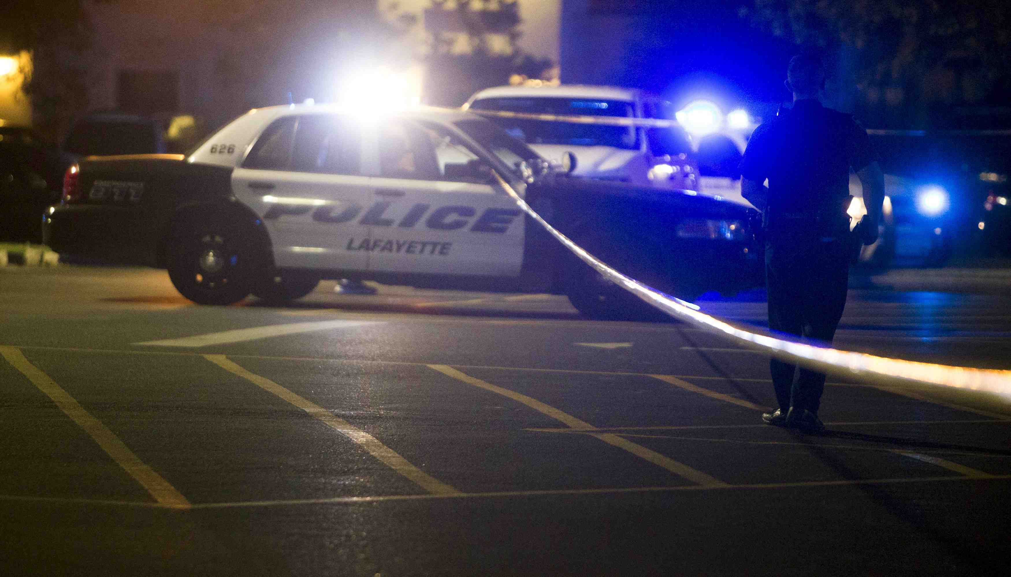 Police stand by at the scene outside the movie theatre where a man opened fire on film goers in lafayette