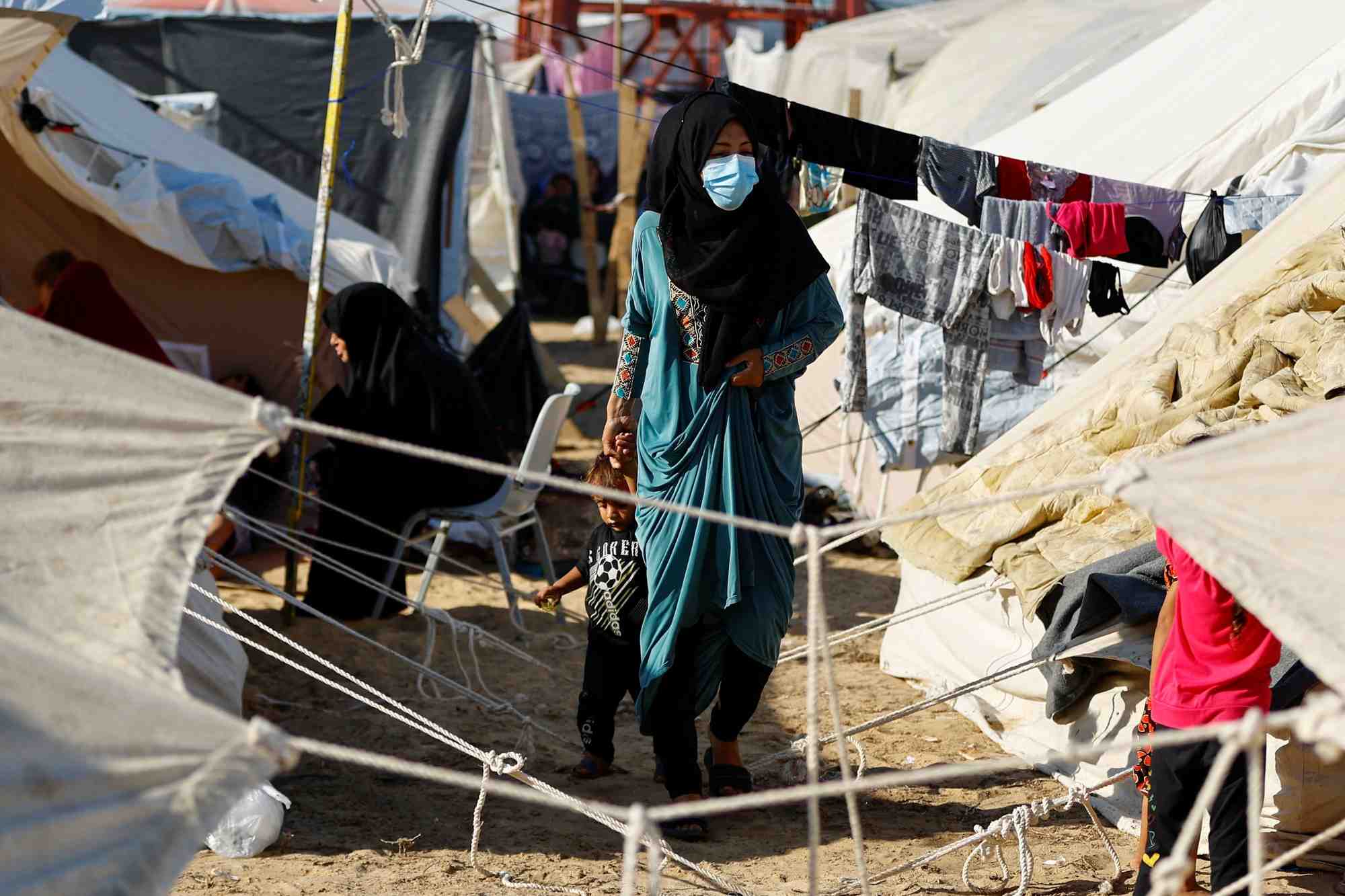Des palestiniens, qui ont fui leurs maisons suite aux frappes israeliennes, dans un camp situe dans un centre gere par les nations unies, a khan younis