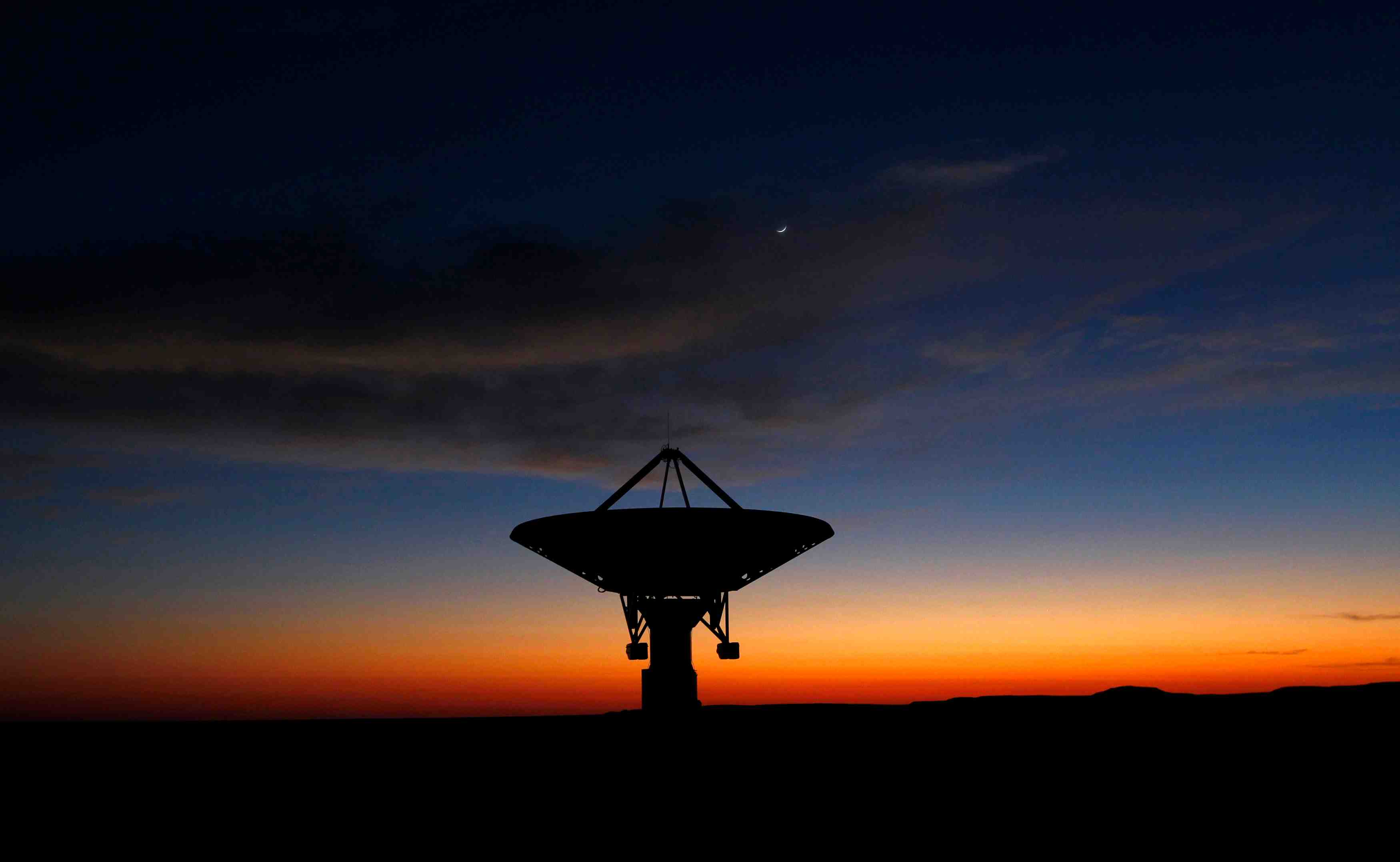 Dawn breaks over a radio telescope dish of the kat-7 array pointing skyward at the proposed south african site for the square kilometre array