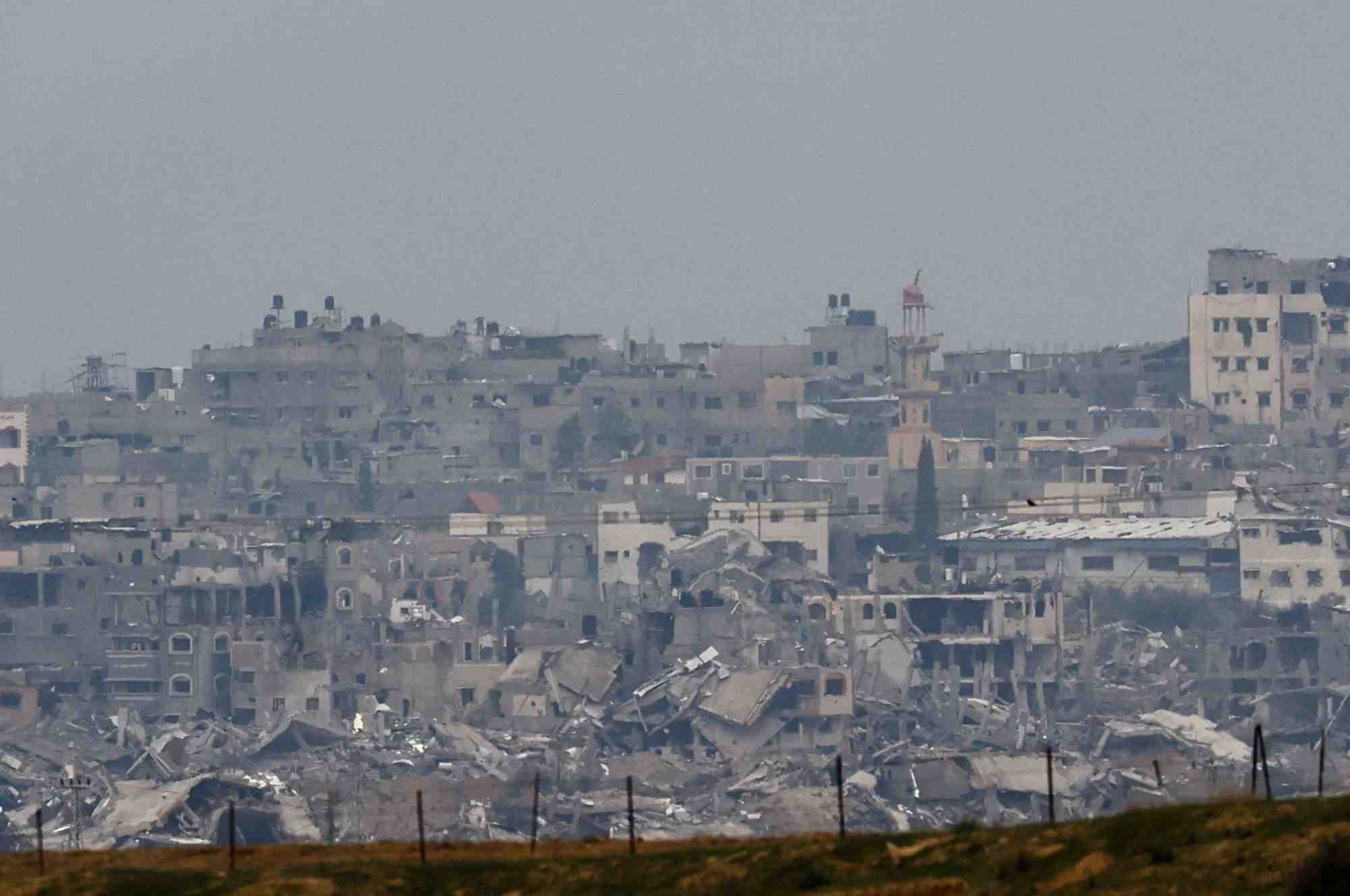 Des batiments detruits gisent en ruine dans la bande de gaza, vus depuis le sud d'israel
